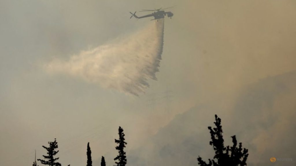 Firefighters in Greece struggle to save coastal resort as winds rage